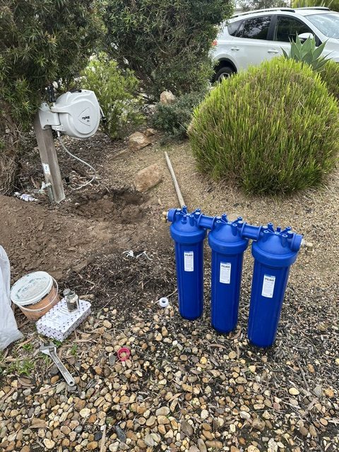 A water filtration assembly prepared on site before it is fitted to the water main